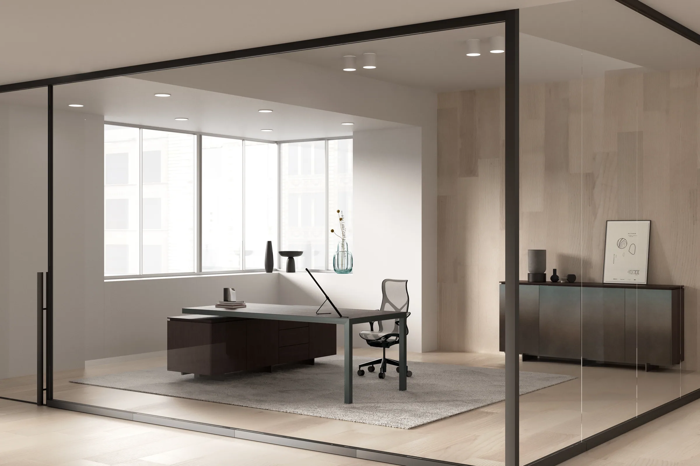 Ufficio direzionale Galvano visto attraverso una parete divisoria in vetro con telaio nero, con tappeto e credenza