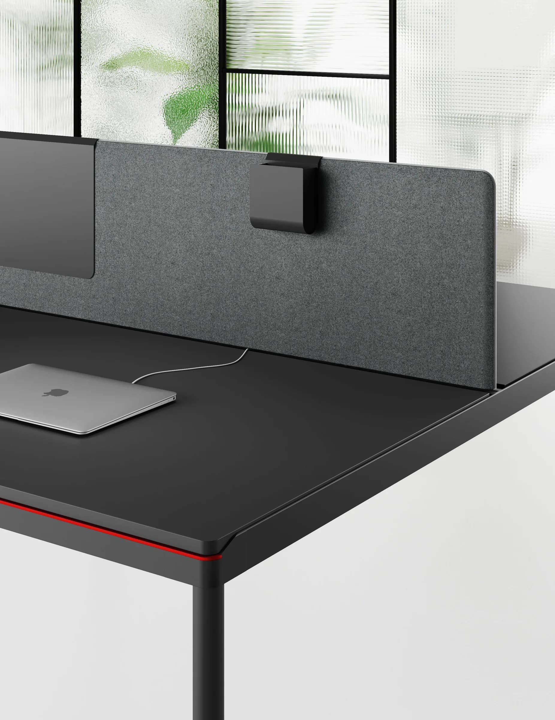 Dettaglio dell'angolo di un piano Round: il filo rosso sul bordo, lo schermo in feltro grigio e il supporto per il monitor